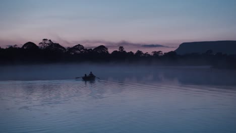 Scenic-shot-rowing-boat-among-fog-at-Dusk