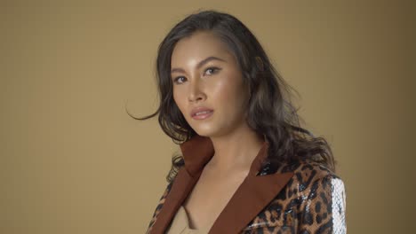Sensual-Asian-woman-at-a-professional-fashion-shoot-wearing-leopard-print-jacket-and-posing-for-headshots