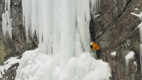 Stunning-frozen-cascade-climber-assessing-buddies-rope-Aerial