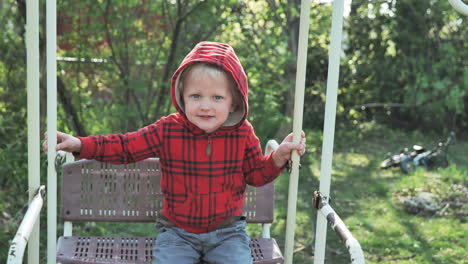Toddler-smiling-on-swing-on-sunny-day