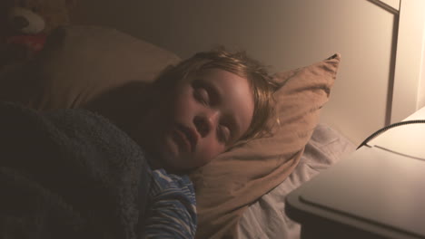 Young-child-sleeping-peacefully-in-bed
