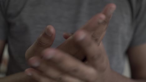 Close-Up-Of-Adult-Asian-Male-Massaging-And-Rubbing-Hands