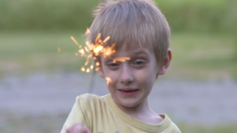 Portrait-of-an-adorable-little-boy-playing-with-a-sparkler