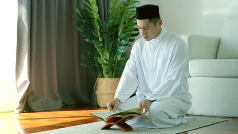 Portrait-of-Asian-Muslim-man-reciting-surah-al-Fatiha-passage-of-the-Qur'an,-in-a-daily-prayer-at-home-in-a-single-act-of-sujud-called-a-sajdah-or-prostration