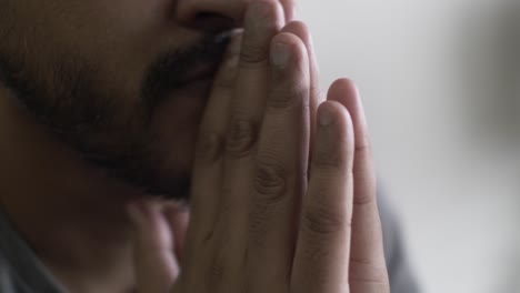 Close-Up-Of-Asian-Male-Hands-Resting-On-Mouth-And-Tapping-Fingers