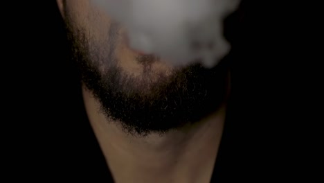 Closeup-on-a-man's-mouth-releasing-smoke-towards-the-camera,-slow-motion