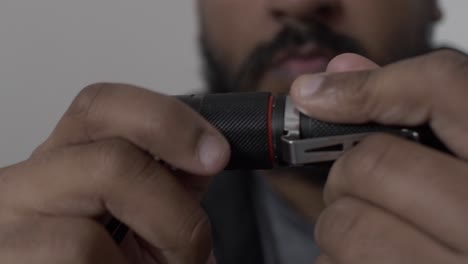Close-Up-Hands-Screwing-On-Battery-Cap-On-Portable-LED-Torch