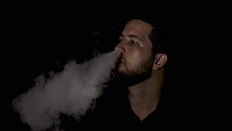 Hombre-Fumando-Humo-De-Su-Nariz-Sobre-Fondo-Negro,-Cámara-Lenta
