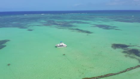 Aerial-circling-of-boat-over-clear-waters-near-Cap-Cana