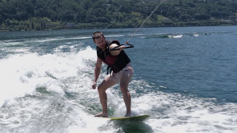 Athletic-guy-wakeboarding-on-lake