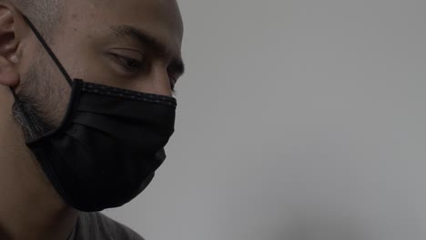 UK-Asian-Male-Wearing-Cotton-Face-Mask-Whilst-Gazing-Downwards