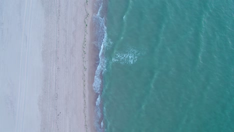 Aerial-view-of-North-Sea-towards-white-sand-beach-at-sunset