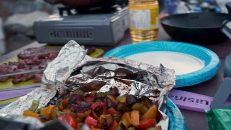 Cooking-and-Assembling-Marinated-Steak-and-Vegetables-on-Camp-Stovetop-During-Daytime