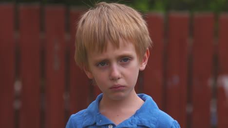 Portrait-of-a-sad-little-boy-turning-toward-the-camera