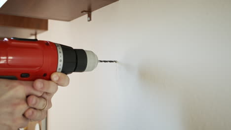 Drilling-into-Concrete-Wall-and-Opening-a-Hole-with-Cordless-Red-Power-Drill-in-slow-mo