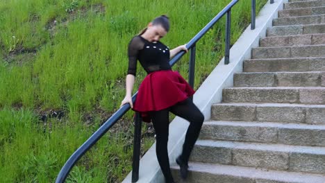 Pretty-female-dancer-does-a-dance-routine-outside-on-the-stairs