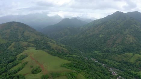 Panoramic-of-bonao,-between-the-green-mountains,-cloudy-sky,-river-in-the-background
