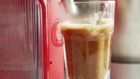 Close-up-of-cold-espresso-coffee,-stirred-with-an-electric-hand-mixer-120fps