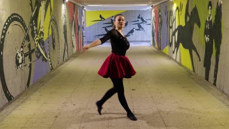 Girl-turns-around-and-spins-while-dancing-in-the-underground-passage
