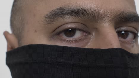 Close-Up-Of-Adult-UK-Asian-Male-Wearing-Balaclava-Indoors-Looking-Directly-At-Camera