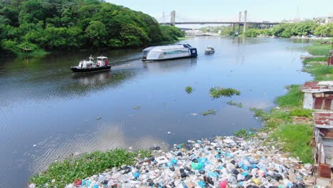 Flight-at-low-altitude-in-the-ozama-river,-contaminated-with-the-large-amount-of-garbage,-interceptor-004-doing-evaluation-to-start-working,-we-observe-the-large-amount-of-accumulated-waste