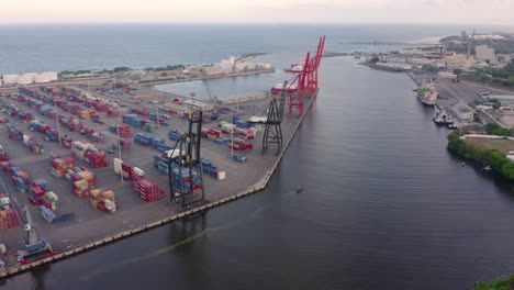 Containers-and-mobile-cranes-at-quay-of-Haina-channel-port,-Dominican-Republic