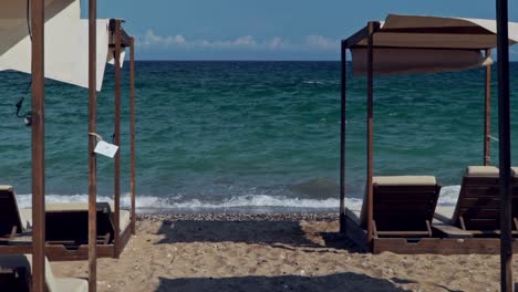 Empty-sunbeams-at-Foinikounta-beach,-located-near-Kalamata,-Peloponnese,-Greece,-summer-of-2020,-slow-motion
