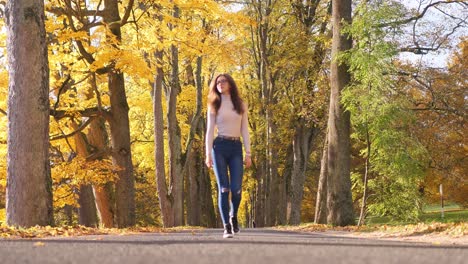 Junge-Frau-Zu-Fuß-Auf-Dem-Weg-In-Einem-öffentlichen-Park-Unter-Bäumen-In-Gelben-Herbstfarben