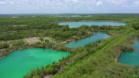Orbit-in-the-blue-lake-cap-cana,-green-water,-green-vegetation,-ideal-place-to-share