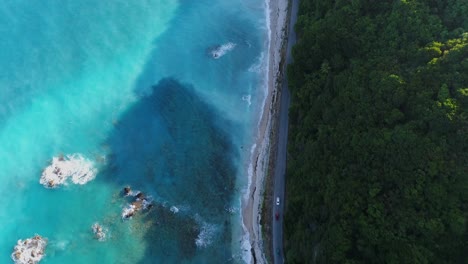 Aerial-shot-with-drone-on-the-coast-of-barahona,-overlooking-the-turquoise-blue-water-caused-by-larimar-or-blue-pectolite-which-is-a-mineral-that-is-abundant-in-the-area