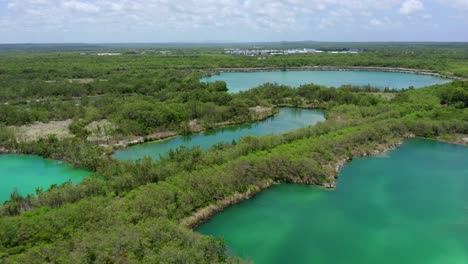 Blue-lake-in-cap-cana,-Punta-cana,-panoramic-shot-from-a-low-altitude-drone