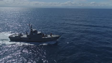 Aerial-tracking-shot-of-coast-guard-patrol-boat-in-open-sea