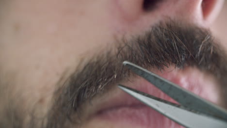 Close-up-shot-of-caucasian-male-trimming-his-mustache