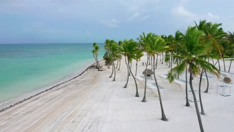 Aerial-forward-on-Playa-Juanillo-white-beach,-Punta-Cana