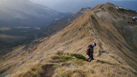 A-hiker-is-walking-down-a-steep-ridge