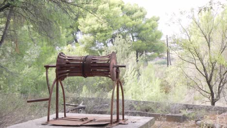 Pan-handheld-footage-of-old-rusty-abandoned-well,-located-at-Kifissia,-Athens,-Greece