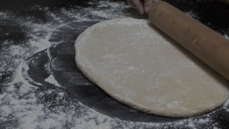 Female-Hands-Rolls-Out-Dough-Using-Rolling-Pin-Cooking