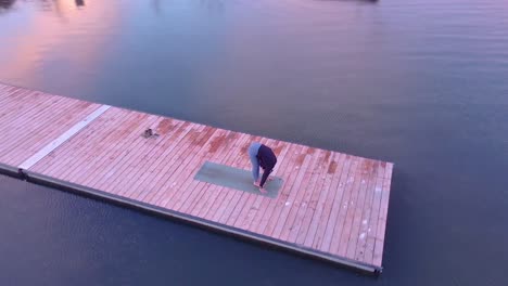 aerial-view-of-a-woman-doing-yoga-on-a-dock