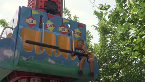Caucasian-kid-enjoys-gravity-game-at-amusement-park-in-Athens,-Greece-4K