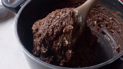 Close-up-footage-of-preparation-of-healthy-energy-bars,-made-with-couverture-chocolate-and-cereal,-slow-motion-120fps