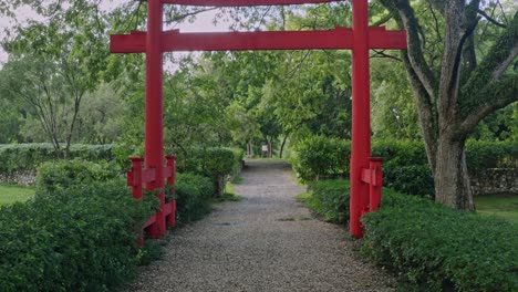 Walk-toward-red-entrance-of-Japanese-Garden,-Santo-Domingo