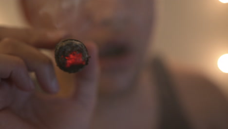Close-Up-of-a-Young-Man-Smoking-a-Cigar
