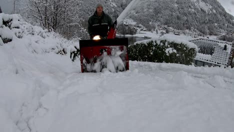 Still-shot-man-cleaning-snow-covered-road-with-snowplow---Blizzard-scenery