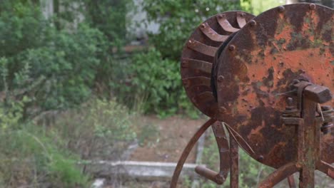Close-up-pan-shot-of-old-rusty-mechanism-of-well-120fps