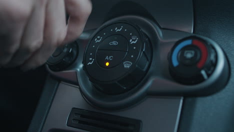 Hand-Pressing-Dashboard-Buttons-for-Car-Air-Conditioner-Fan-and-Turning-Knobs-for-Heat-and-Air-Intake-Settings-in-slowmo
