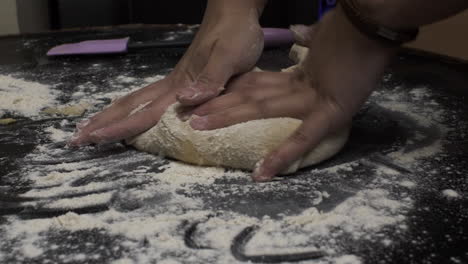 Female-Hands-Kneading-Dough-In-Flour-On-Table