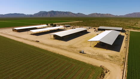 Wide-drone-shot-of-covering-or-shelters-on-a-farm