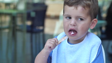 Gimbal-shot-of-toddler-eating-strawberry-ice-cream
