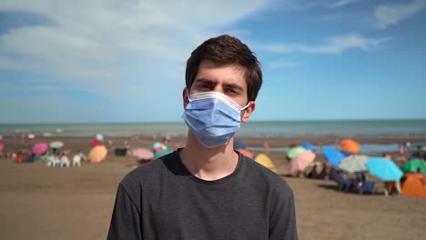 Guy-Wearing-Disposable-Facemask-At-Beach-During-COVID-19-Pandemic-In-Monte-Hermoso,-Buenos-Aires,-Argentina