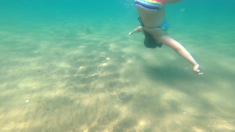 Young-Caucasian-Holiday-Tourist-Swimming,-Over-and-underwater-shot